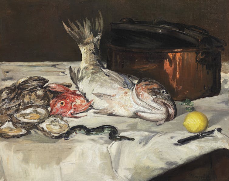 a dead fish, oysters and a lemon on a table
