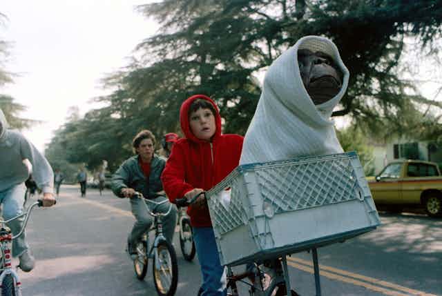 Film still, Elliott and ET on a bike