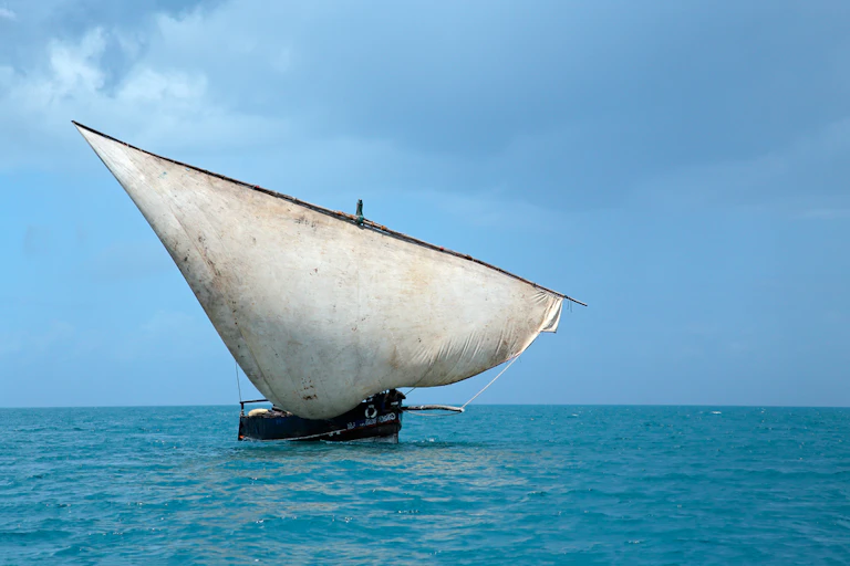 A small ship on blue water.