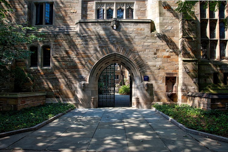 A doorway is seen in a university courtyard.