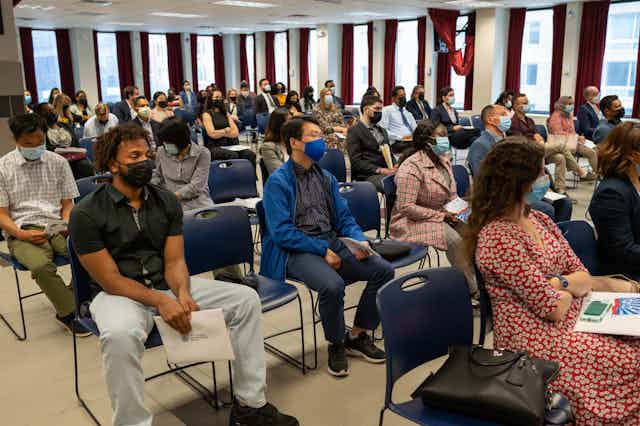 People participate in a special Memorial Day naturalization ceremony at a government immigration office.