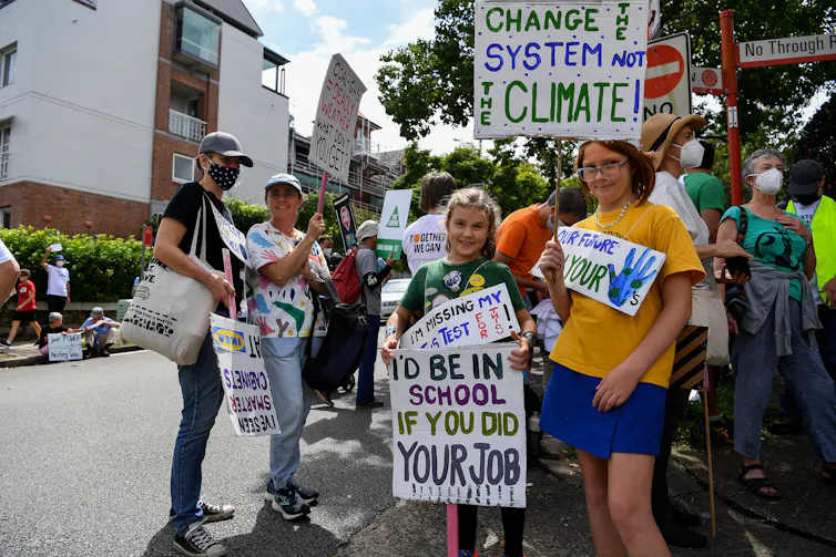Protesting students hold up placards