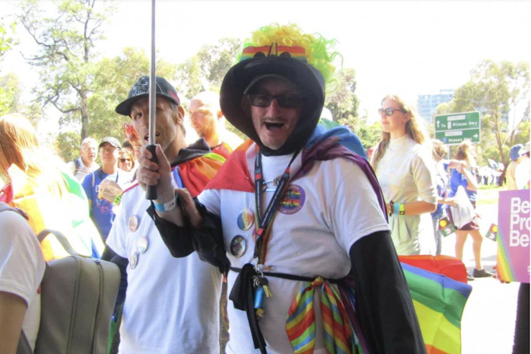 People marching in rainbow colours