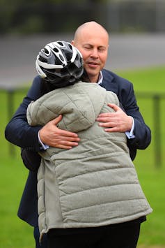 Former treasurer Josh Frydenberg is hugged by a constituent