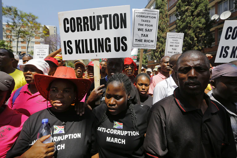 Men and women carry anti-corruption posters