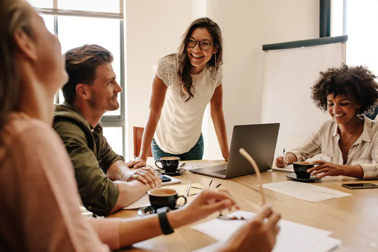 A group of young people collaborating at work.