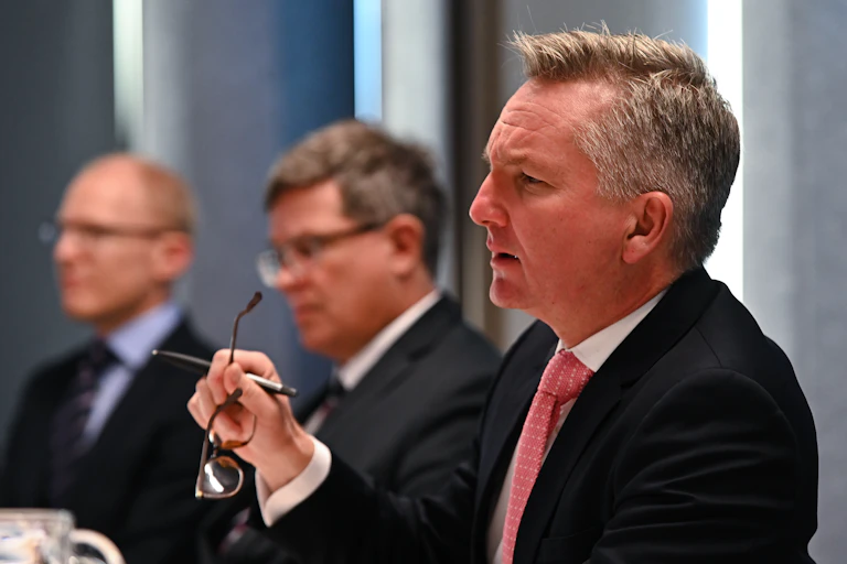 Chris Bowen holding glasses