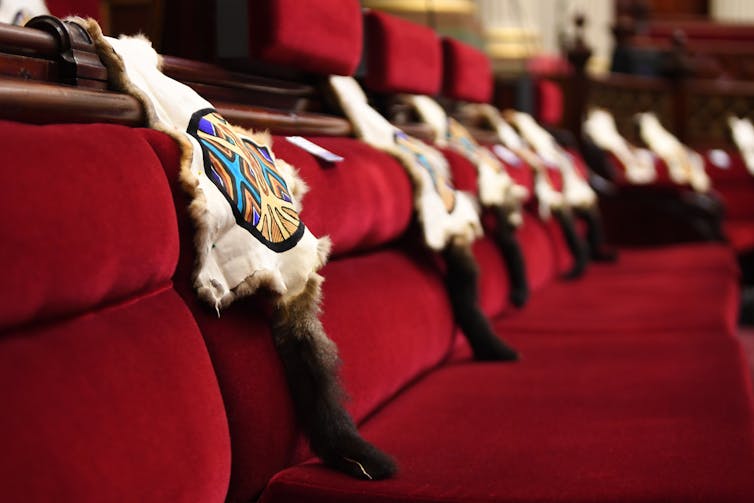 Possum skins are draped over seats in Victorian parliament house for First People's Assembly of Victoria's meeting.