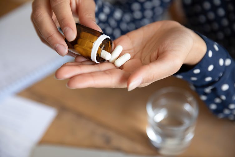 Pills in woman's hand