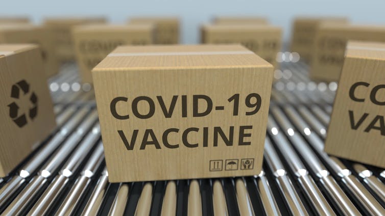 Box printed with COVID-19 vaccine on a factory production line