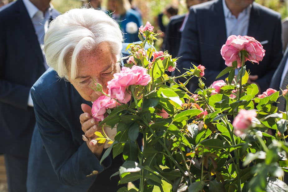 Christine Lagarde smelling a rose