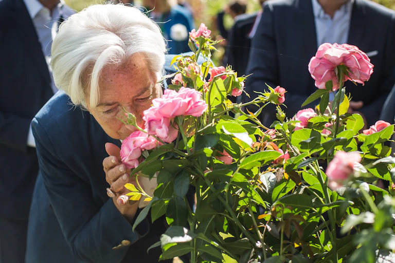 Christine Lagarde smelling a rose