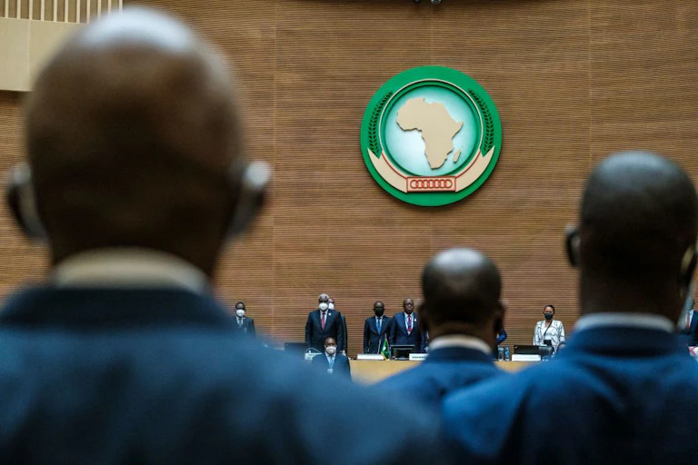 Men standing before the start of a meeting.