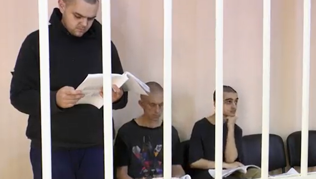 Britons Aiden Aslin and Shaun Pinner with Moroccan comrade Brahim Saadoun in a jail cell examining court documents.