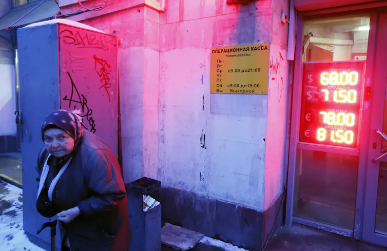 Old woman leaving a bureau de change in Moscow
