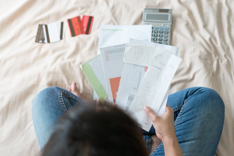 Woman with bills and credit cards.