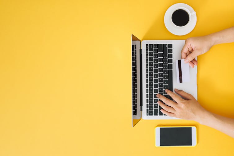 Computer, coffee, phone credit card, yellow background