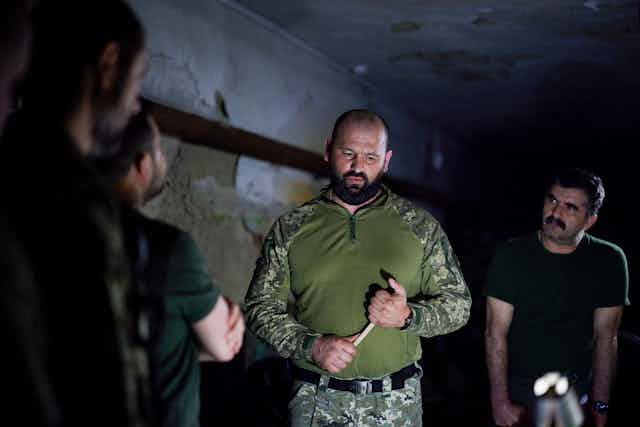 Soldiers briefing Ukrainian president Zelensky.
