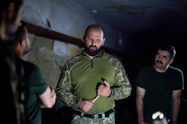 Soldiers briefing Ukrainian president Zelensky.