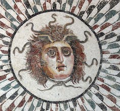 Mosaic showing a head with snakes.