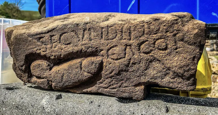 Part of a Roman wall with graffiti on it.