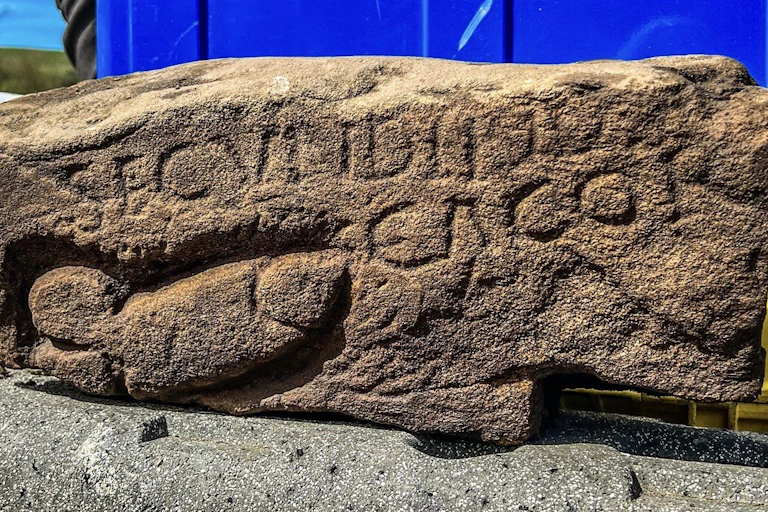 Part of a Roman wall with graffiti on it.