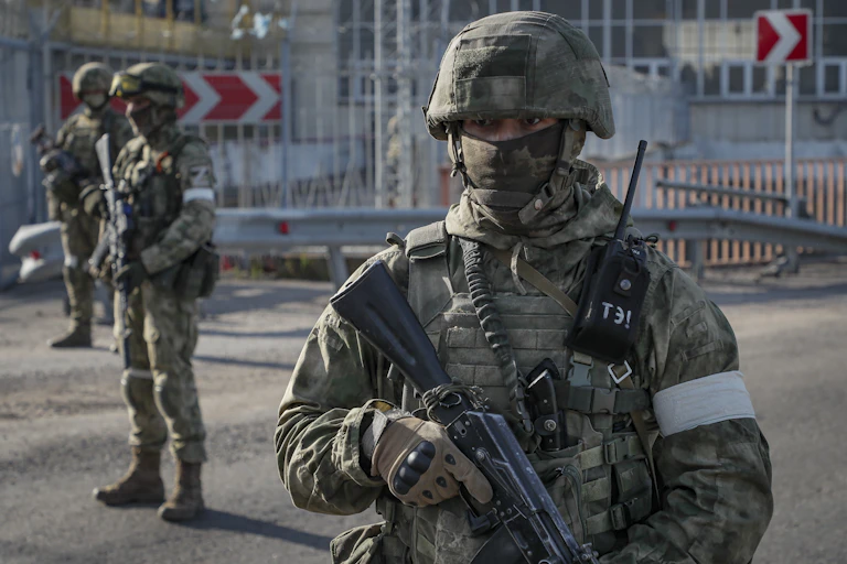 Russian soldiers on guard outside the Kakhovka Hydroelectric Power Plant (HPP) on the Dnieper River in Kakhovka, near Kherson, May 2022.