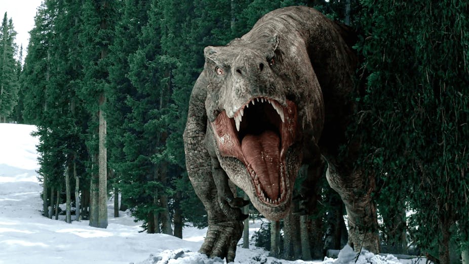T-Rex emerges from a snowy forest roaring