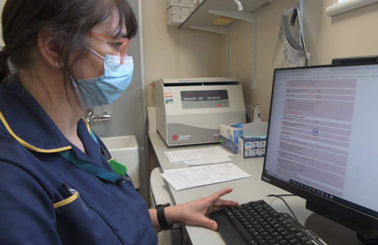 Hospital nurse looking at computer screen