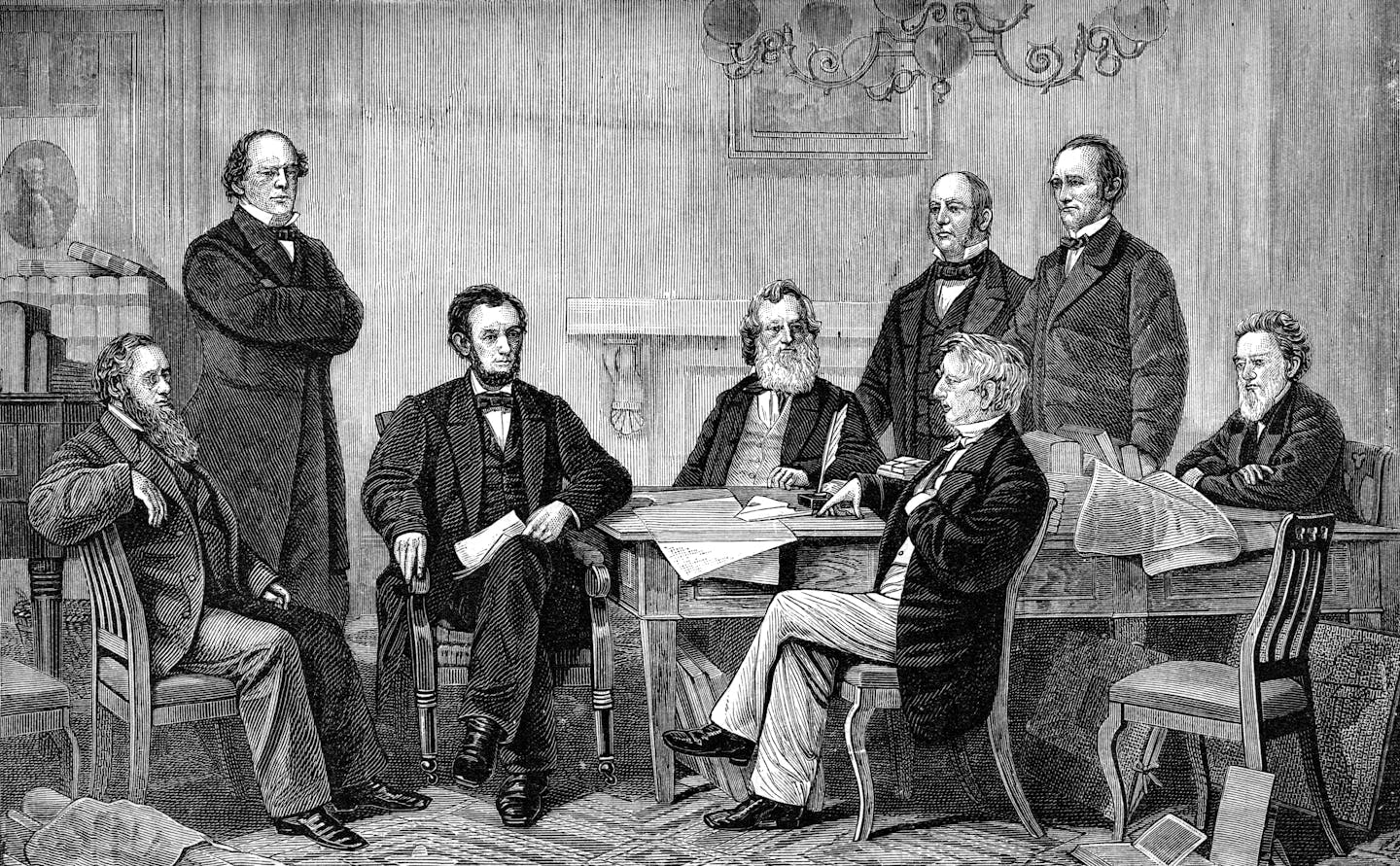 Seven white men gather around a table to watch President Abraham Lincoln sign the Emancipation Proclamation.