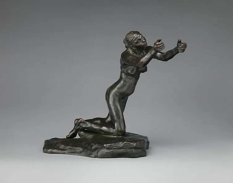 A statue of a begging woman.