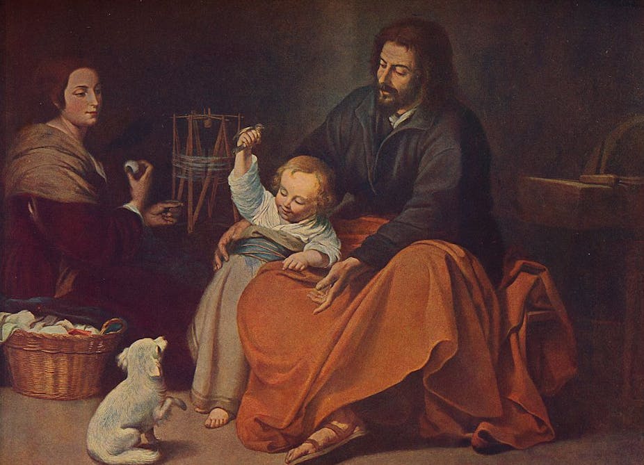 A painting shows a woman seated on the floor while a seated man plays with a toddler clutching a small bird, and a dog sits in front of them.