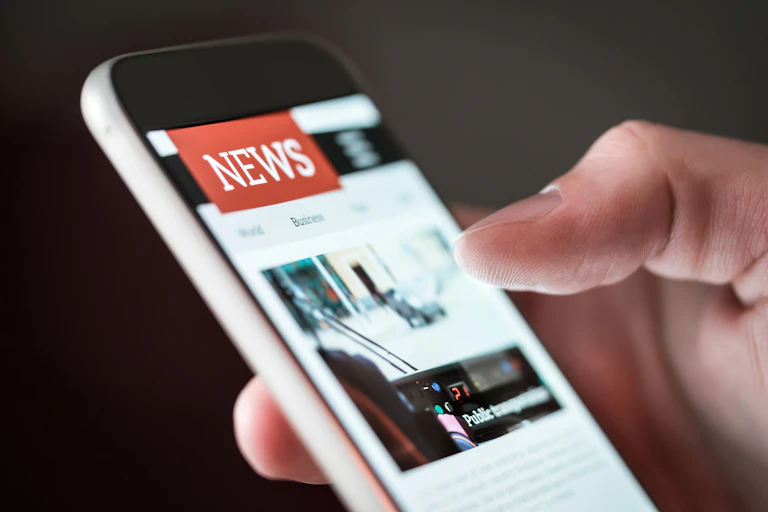 Someone scrolling through the news on their cellphone