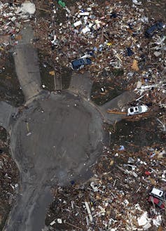 An aerial photo of a cul-de-sac with debris at the end of each driveway, where houses once stood.