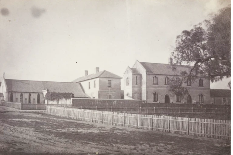 Historical photo in sepia tones of a cathedral, convent and school