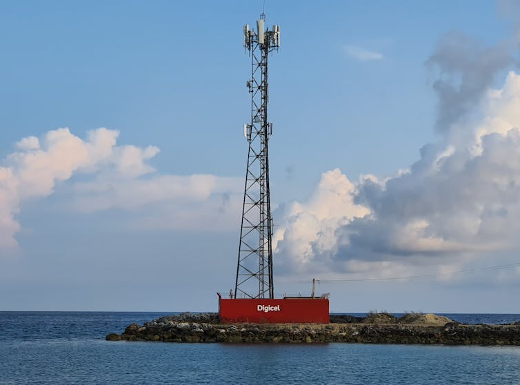 A photo of a mobile phone tower on a rocky island.