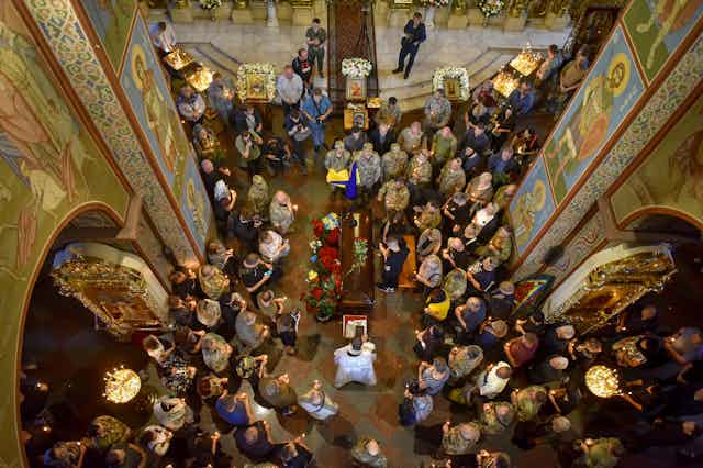 Downward view of a funeral ceremony for Ukrainian serviceman Volodymyr Prymachenko at St. Michael's Golden-Domed Monastery in Kyiv.