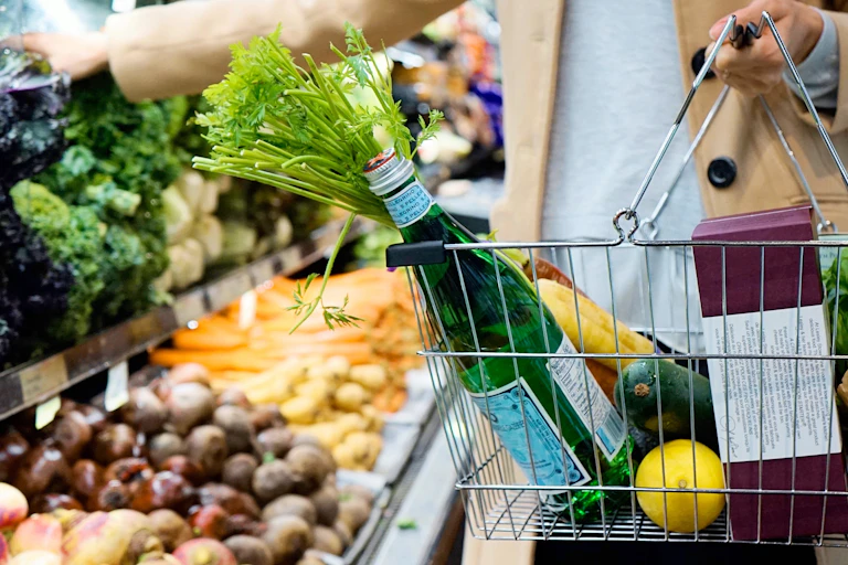 Person shopping with a basket of groceries.