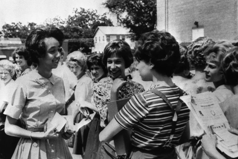 A young Black woman stands with a group of other students