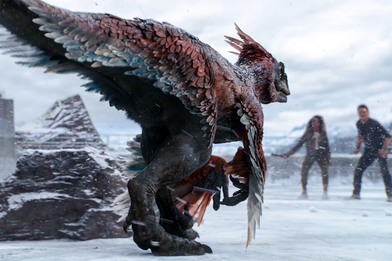 Film image of a velociraptor with feathers.