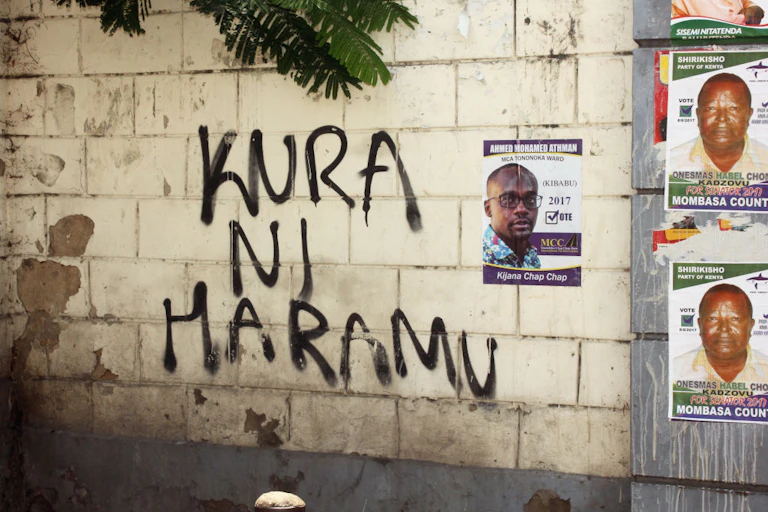 Graffiti and election posters on a wall