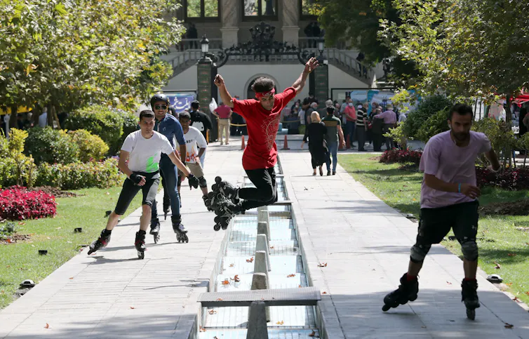 An Iranian practices rollerblading in a street of Tehran, Iran, 24 September 2021