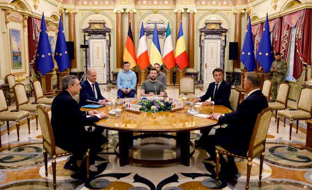 Italian Prime Minister Mario Draghi, German Chancellor Olaf Scholz, Ukrainian President Volodymyr Zelensky, French President Emmanuel Macron and Romanian President Klaus Iohannis sit round a table at the Mariinsky Palace, in Kyiv, JUne 16 2022.