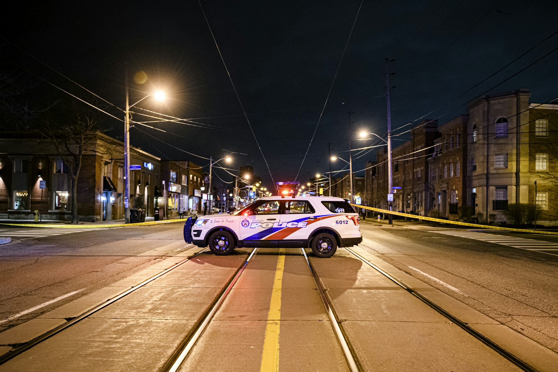 A Toronto police cruiser is seen parked in the middle of a road.