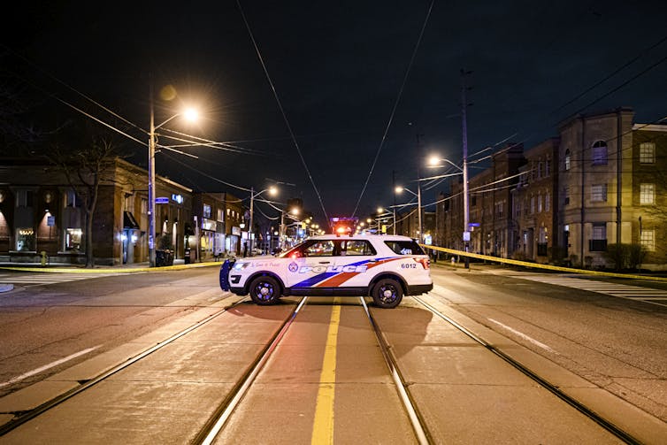 A Toronto Police Cruiser Is Seen Standing In The Middle Of A Road.