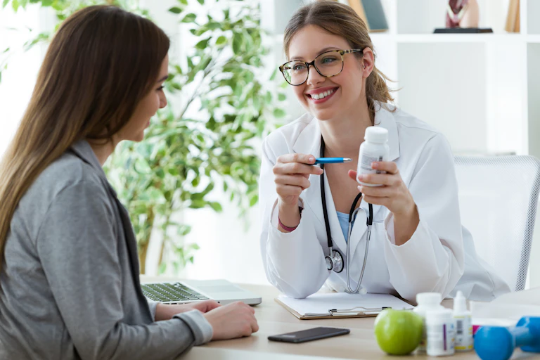 Doctor pointing to a bottle of pills