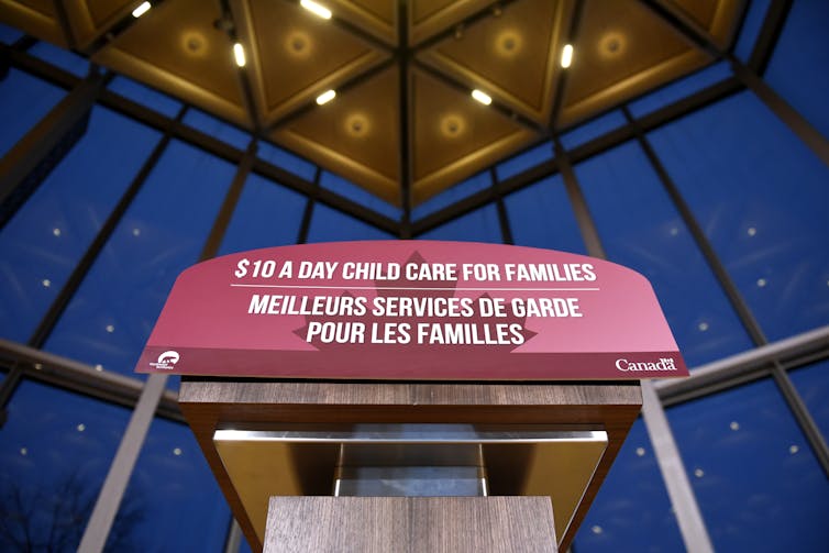 A podium is seen that says '$10 a day child care for families.