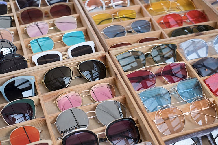 A table with many colored sunglasses.
