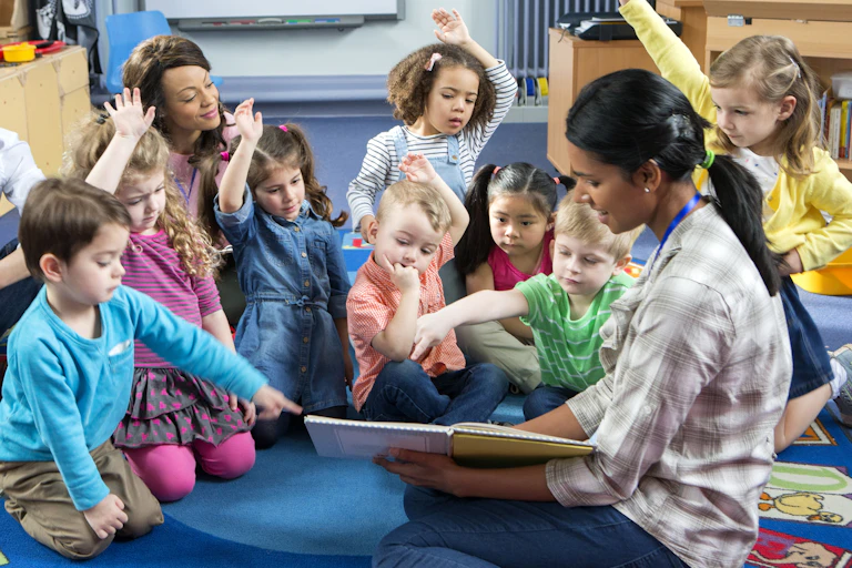 Teacher holding a book asks preschoolers a question