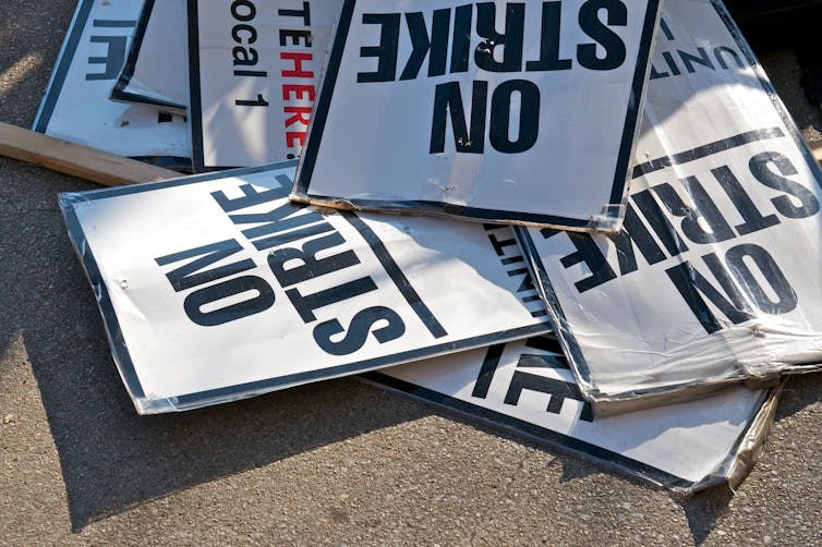 Pile of placards, signs that say 